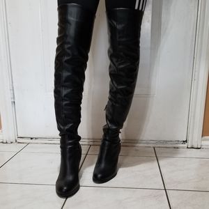 Long black guess heel boots.